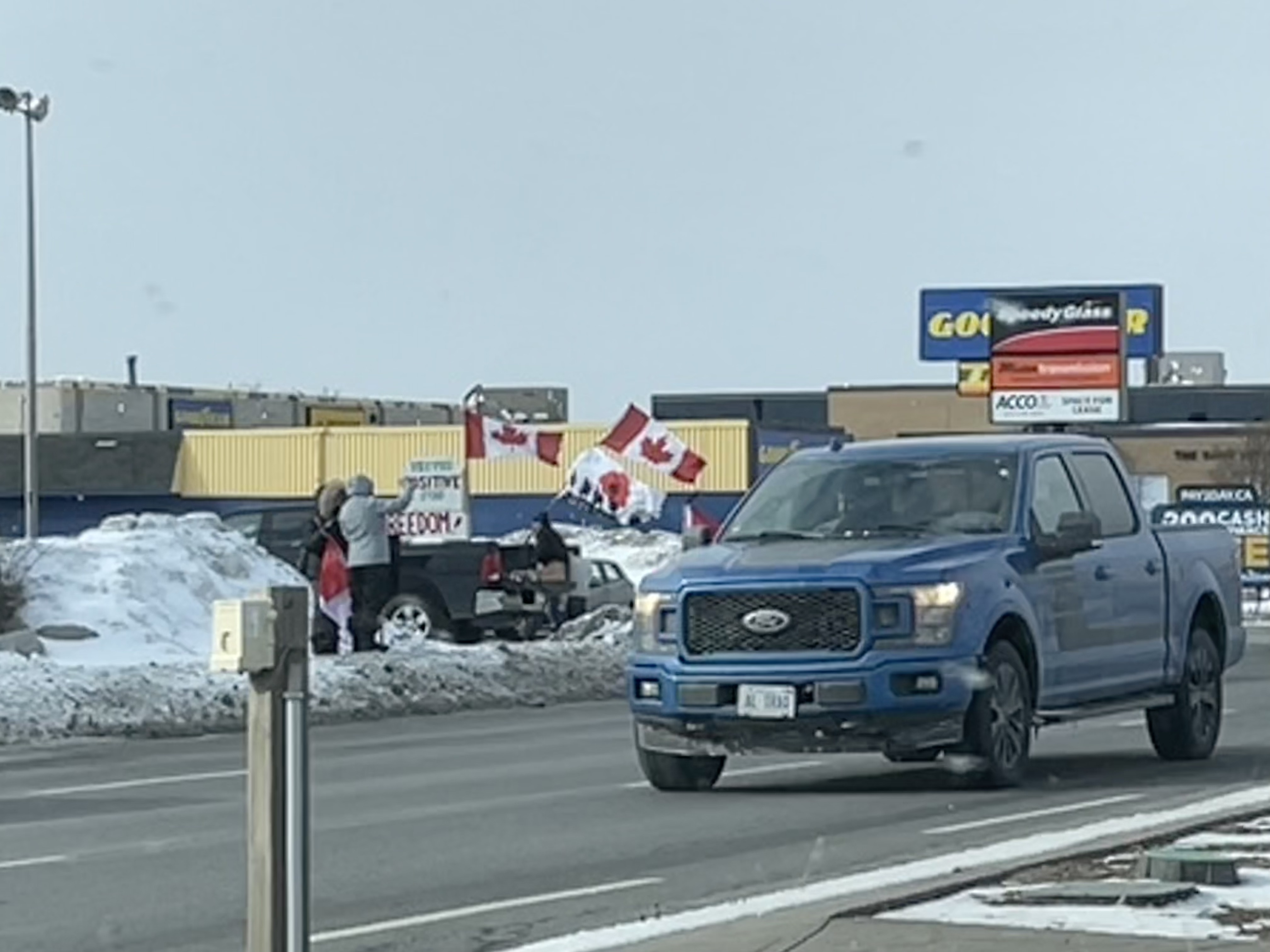 A big Ford and a contingent of folks who have