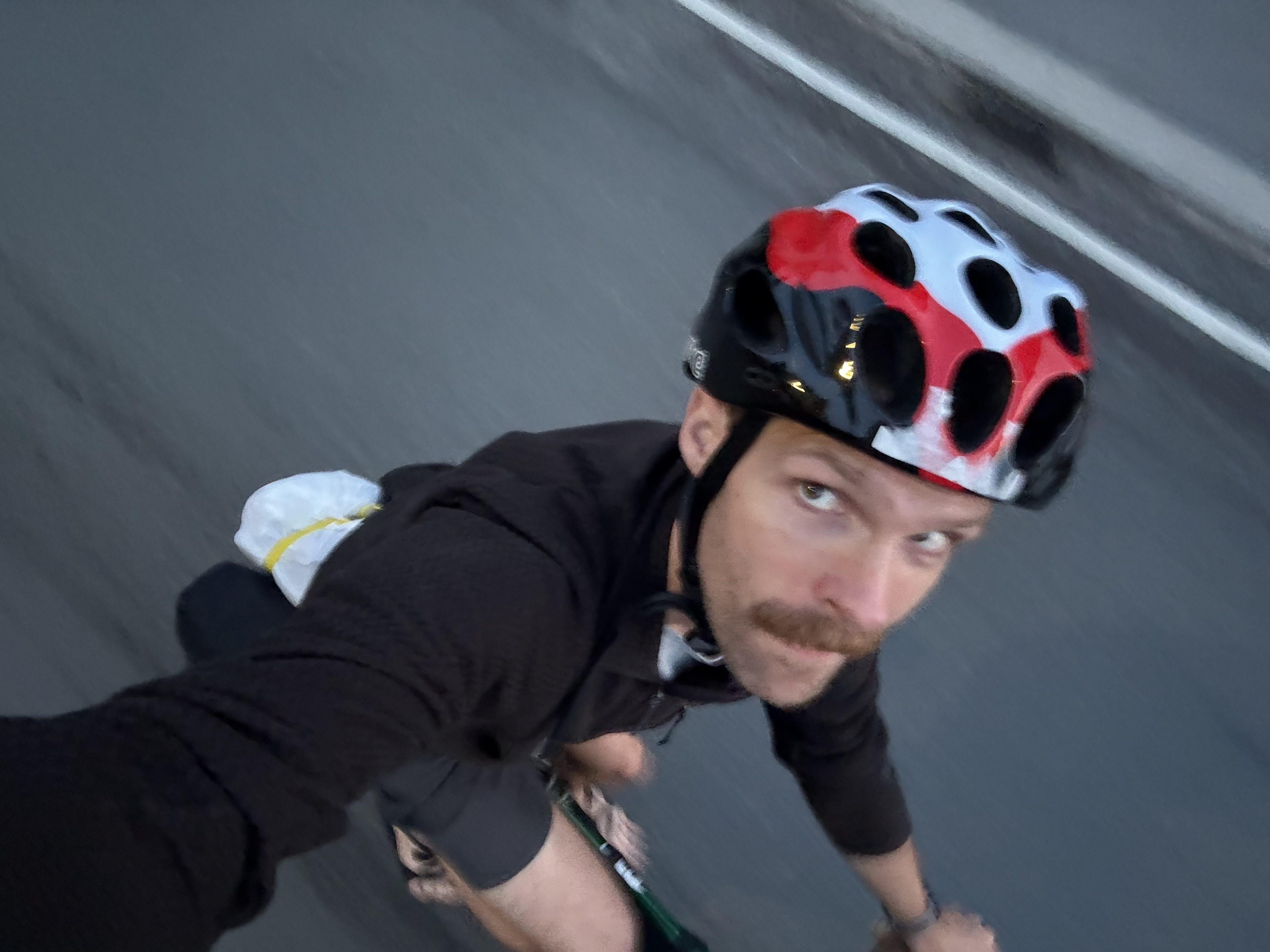 An overhead shot of me riding a bicycle, with the road blurring by in the background
