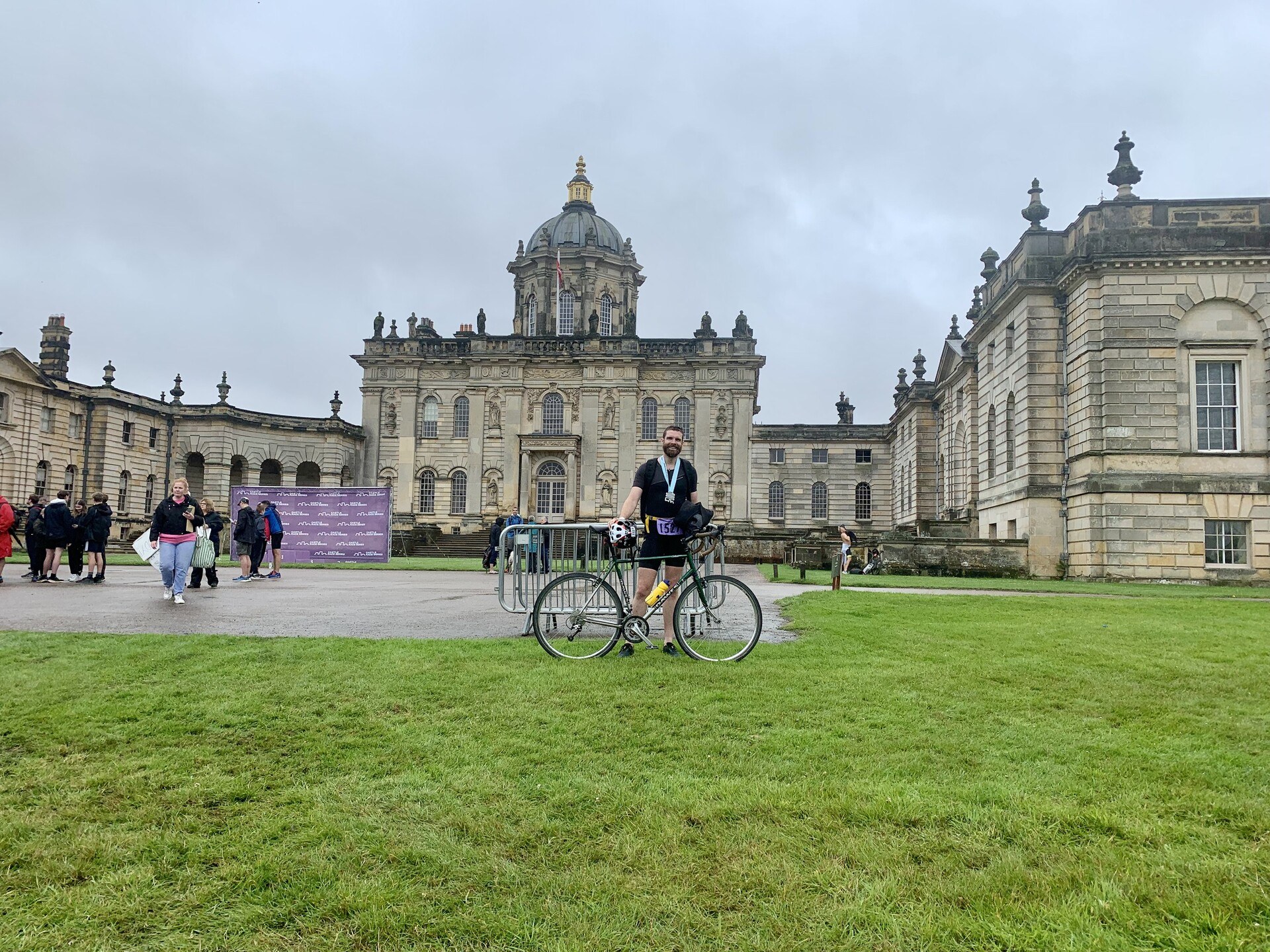 Me, standing with my bike on a grassy lawn with Castle Howard in the background.