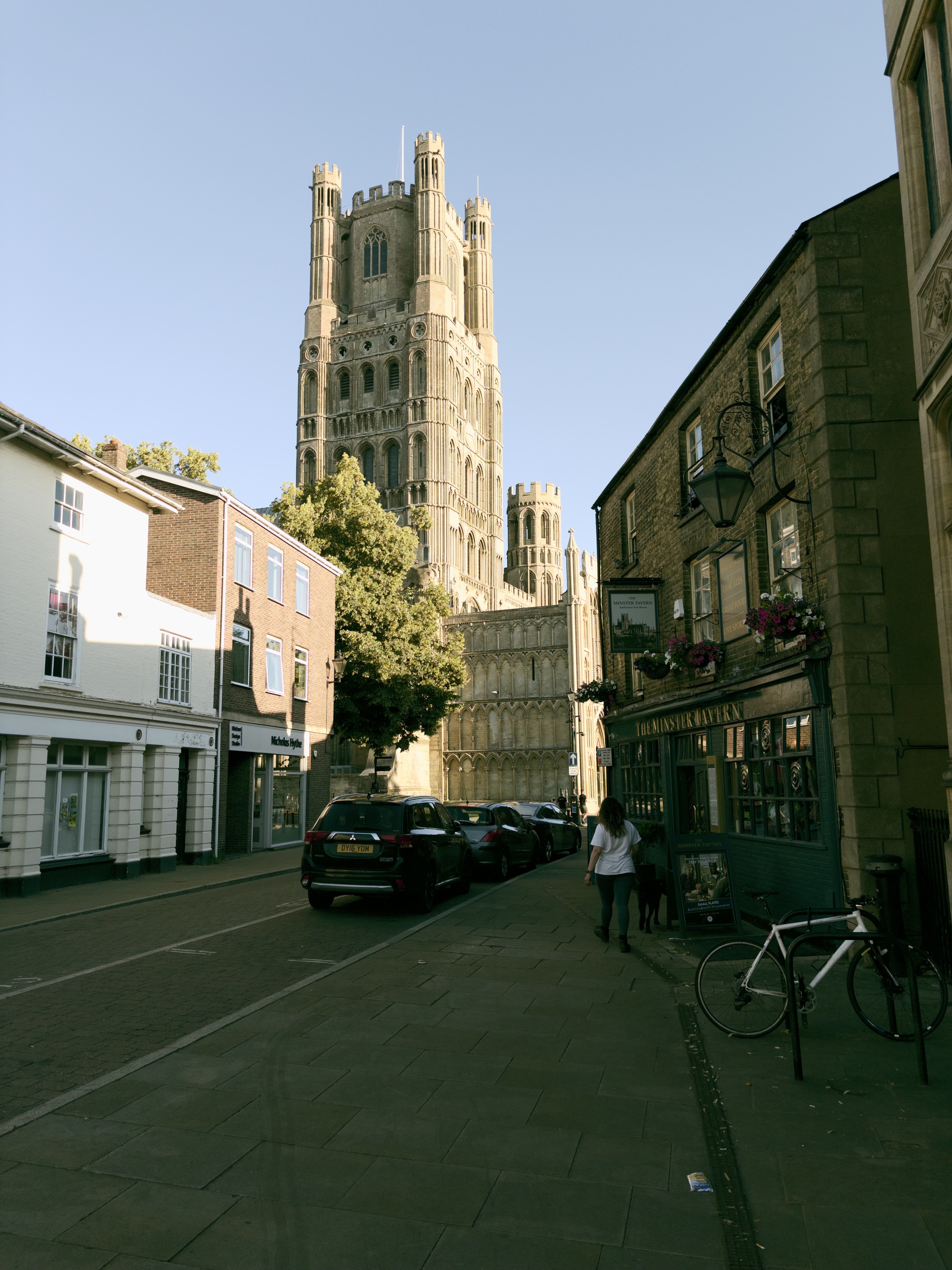 A wider view of Ely Cathedral from the streets, with Georgian and Victorian buildings flanking.