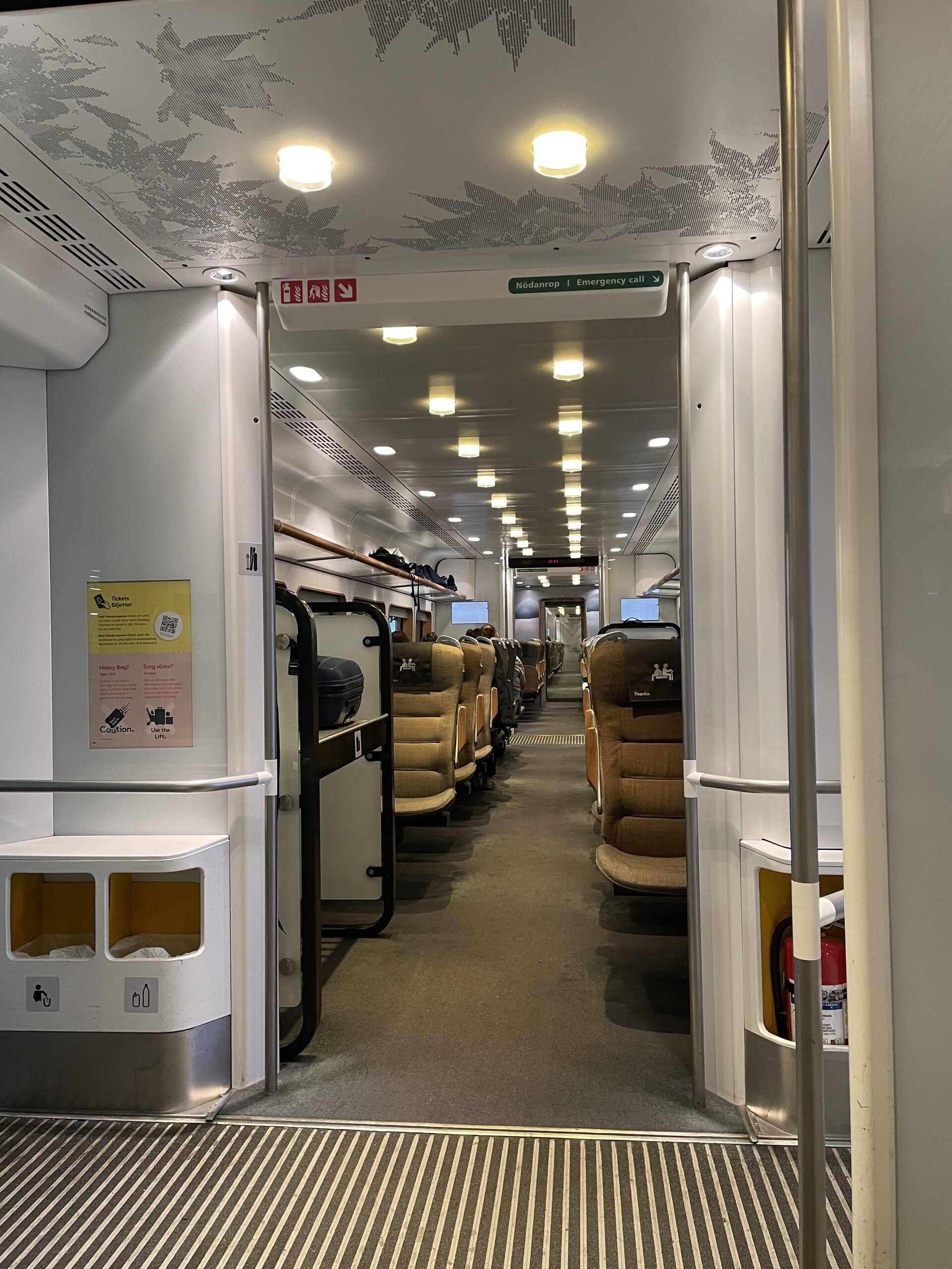 Looking down the length of the Arlanda Express, with nice wool seats and soft overhead lighting