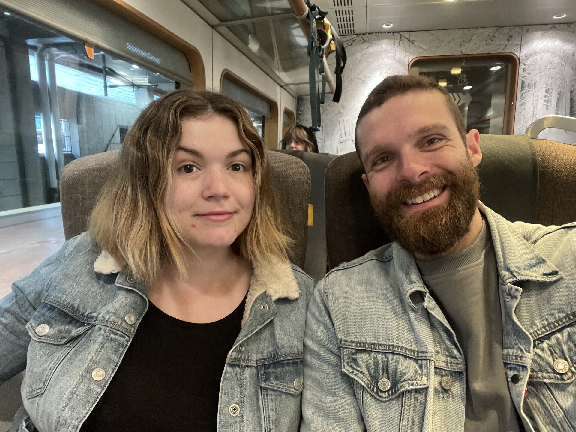 Sam and I smiling in our seats on the Arlanda Express train back to the airport