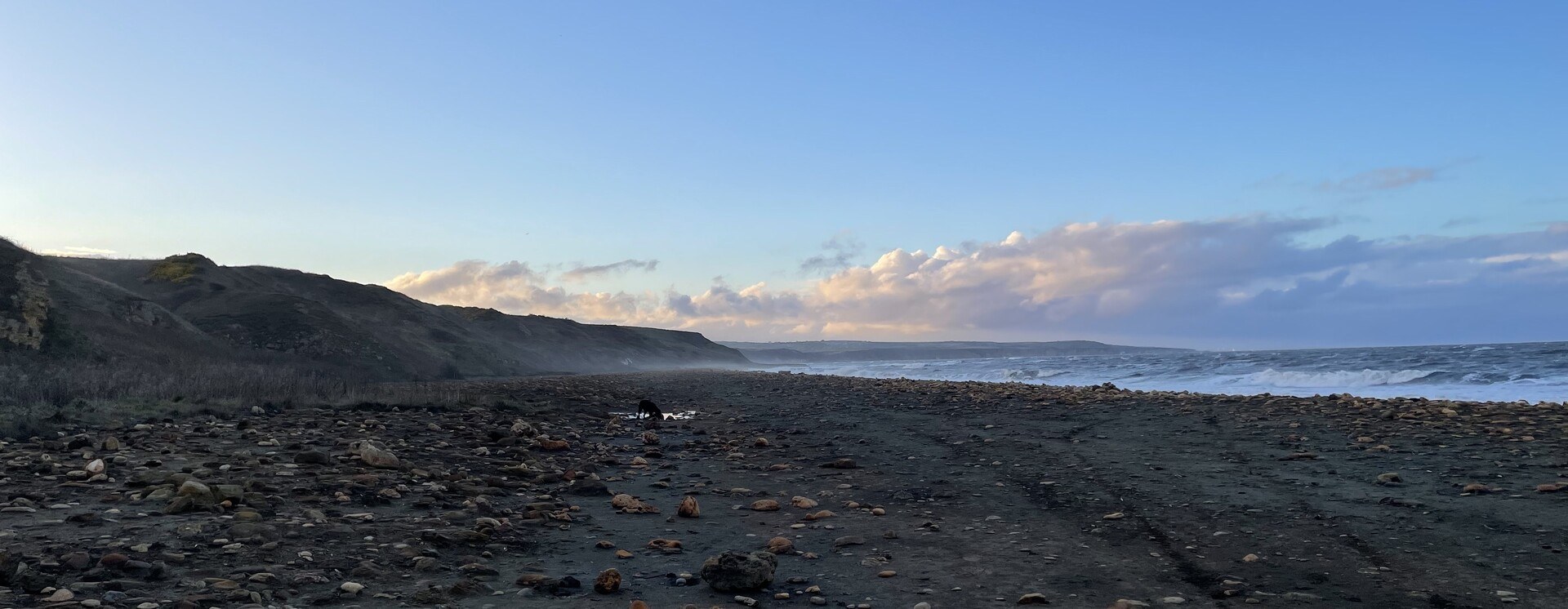 A long beach with sea fret coming in off Blackhall Rocks