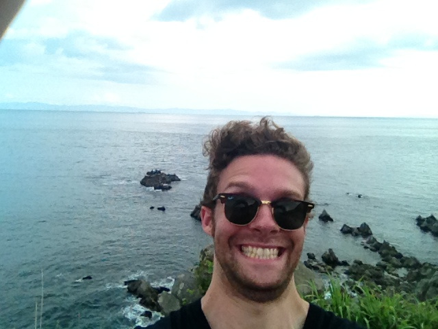 Selfie of me in front of the Tsugaru Straits, mugging for the camera with a big doofy grin