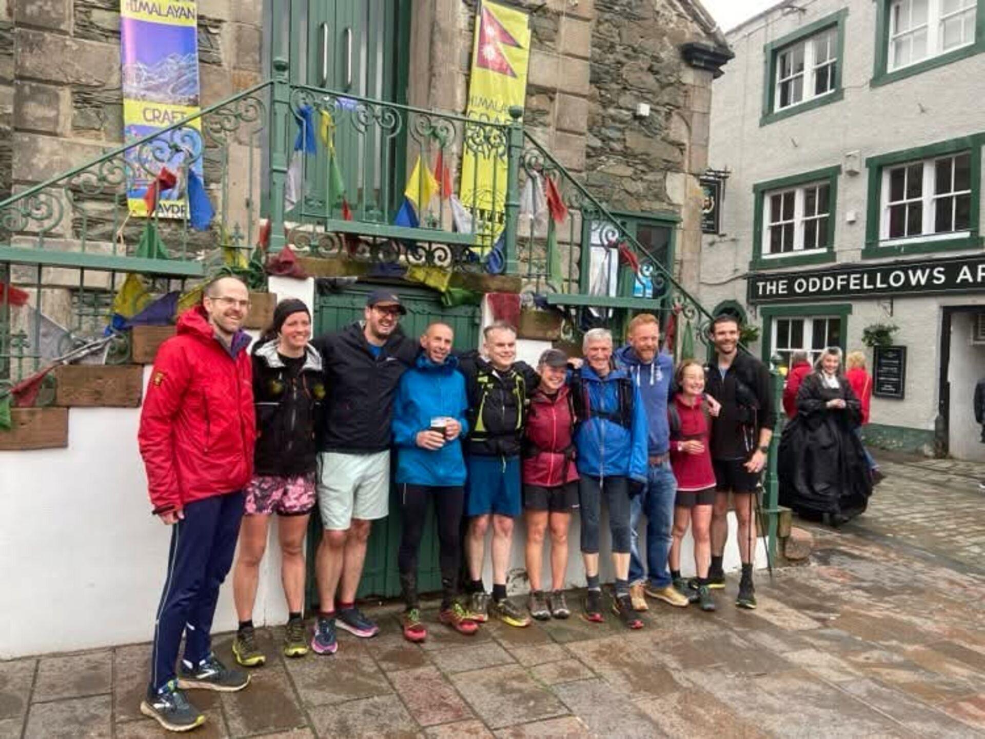 A row of runners standing in front of the Moot Hall in Keswick