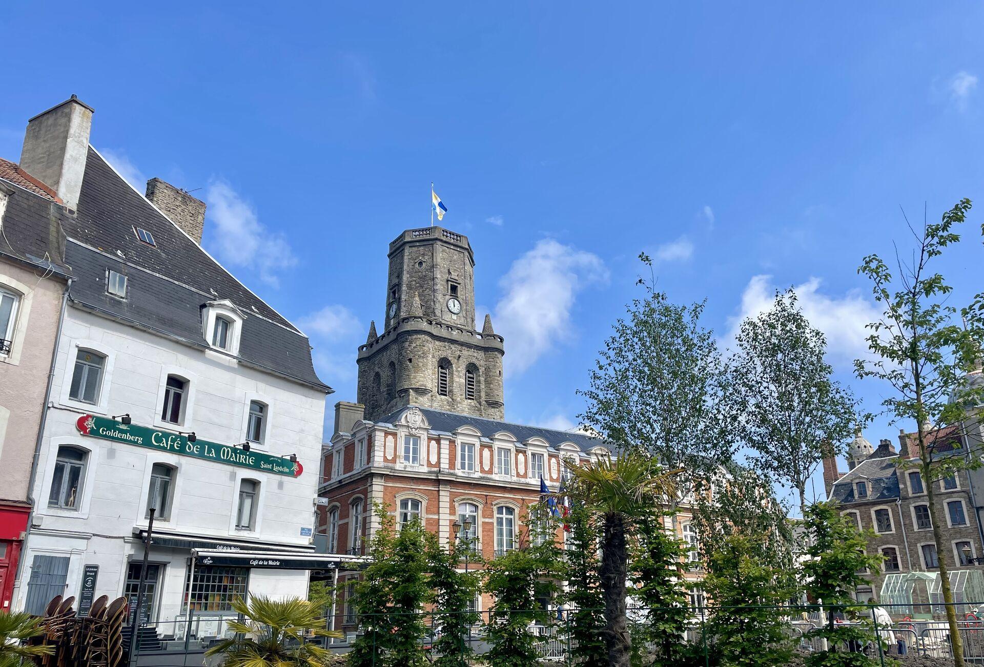 The belfry clock tower above the varied cafés and apartments overlooking the town square in Boulogne