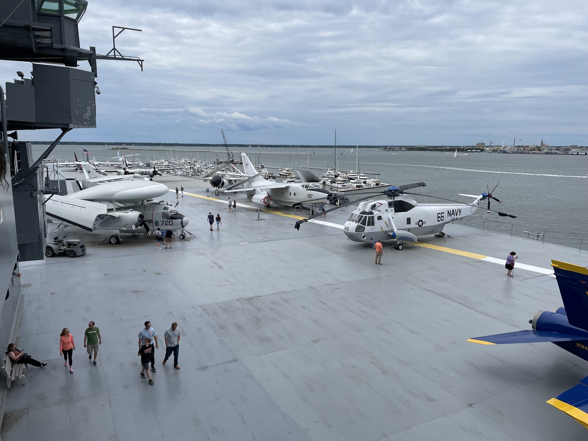 A view of the flight deck of the USS Yorktown, with bored-looking tourists sort of milling about between long-decommissioned aircraft.