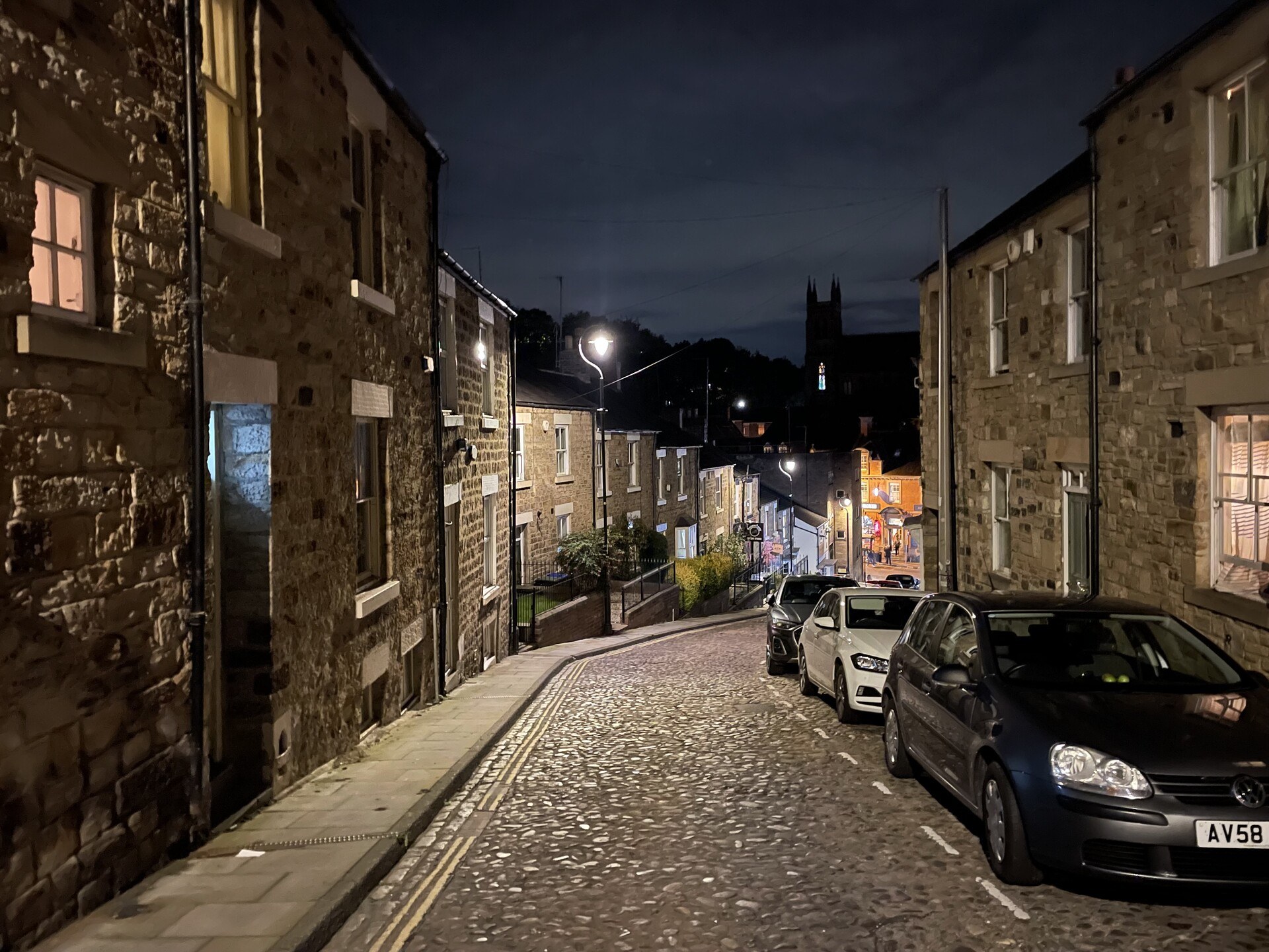 Looking down a picturesque cobblestoned street in Durham, at night