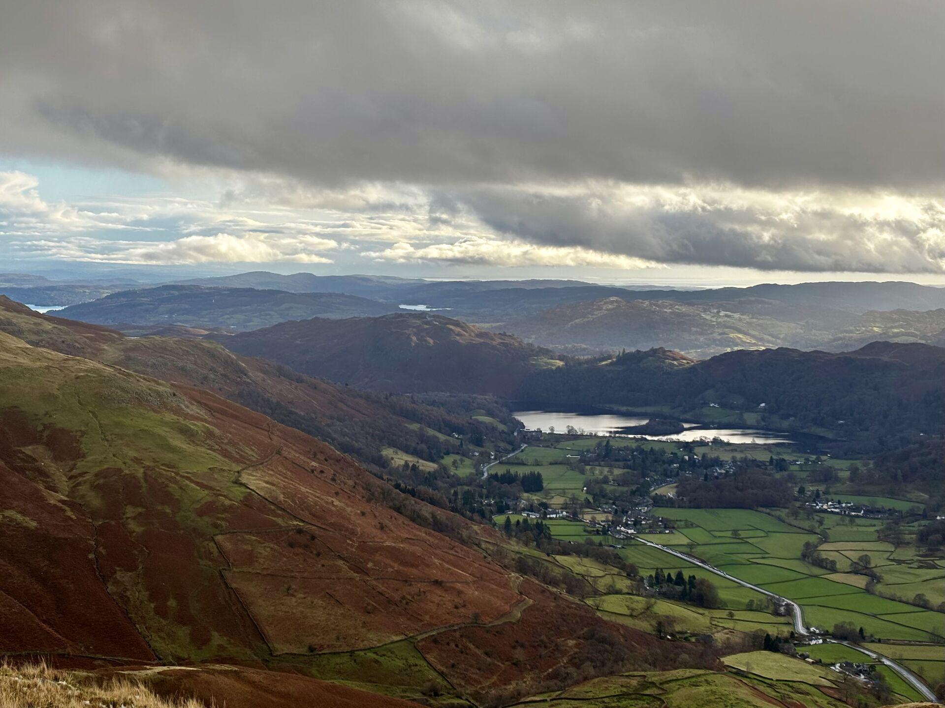 A view over the green and brown hills surrounding Grasmere in the Lake District