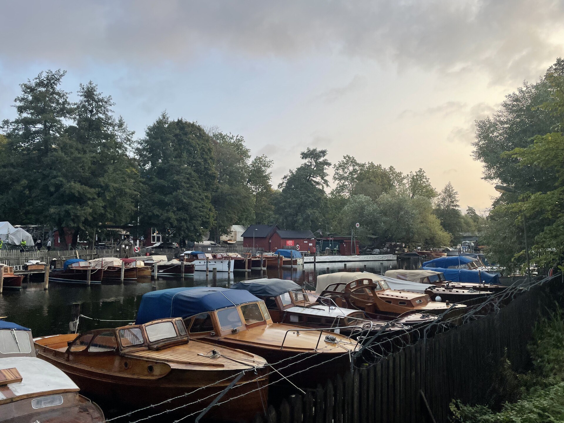 Wood-hulled boats lined up neatly at a marina along Söder Mälarstrand