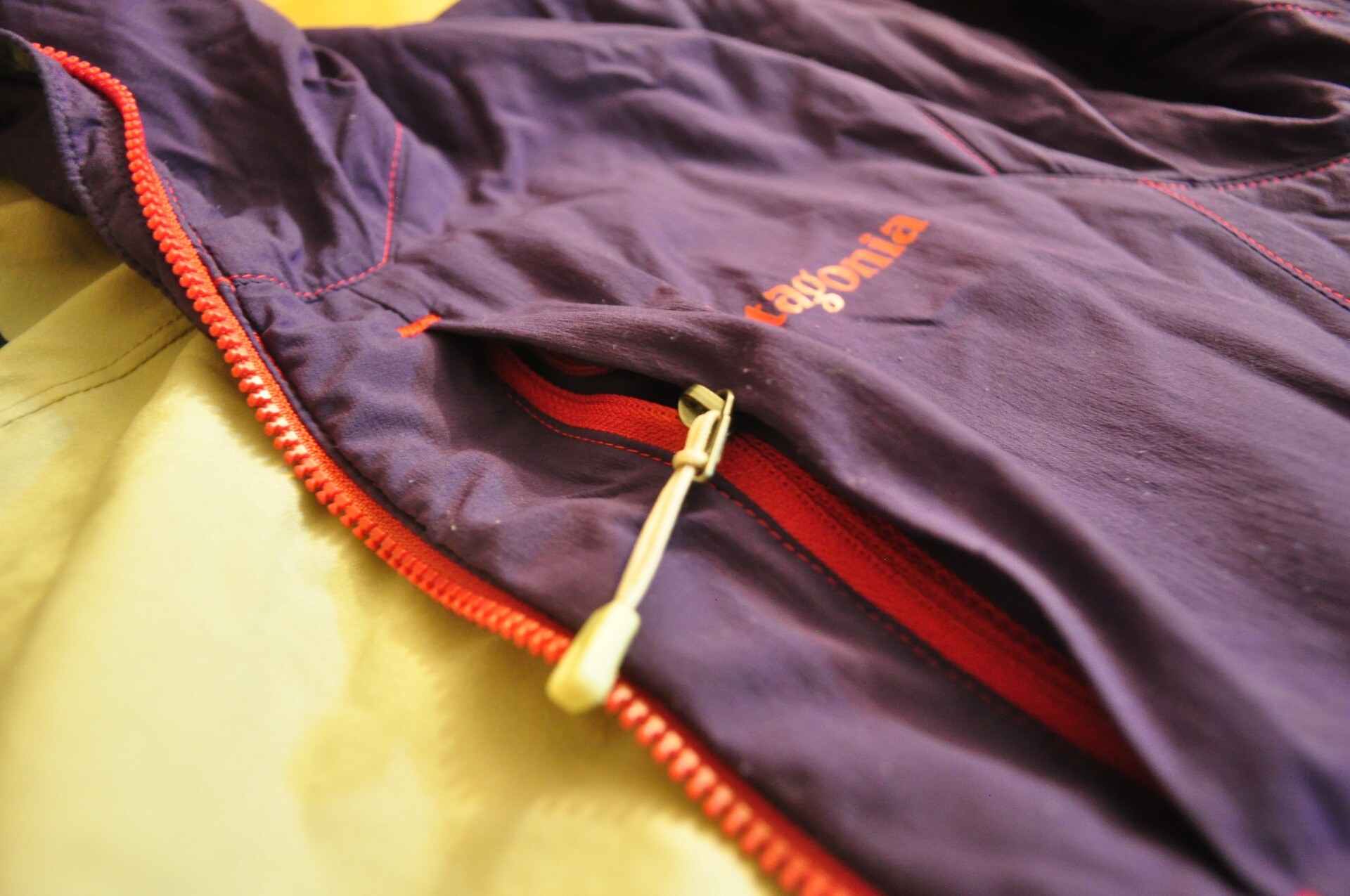 A chest zipper caught on the jacket's thin material