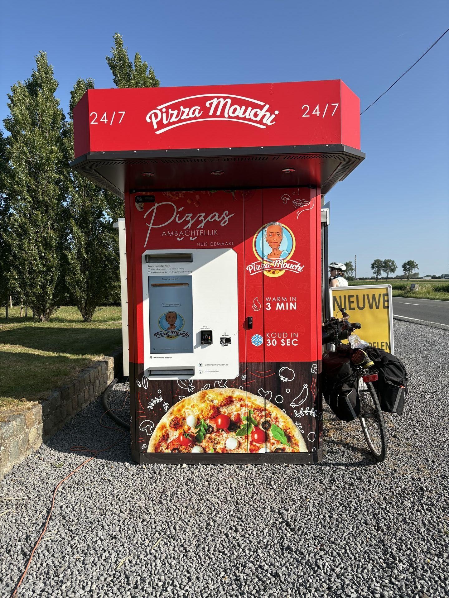 A large vending machine serving pizza by the side of the road in Belgium