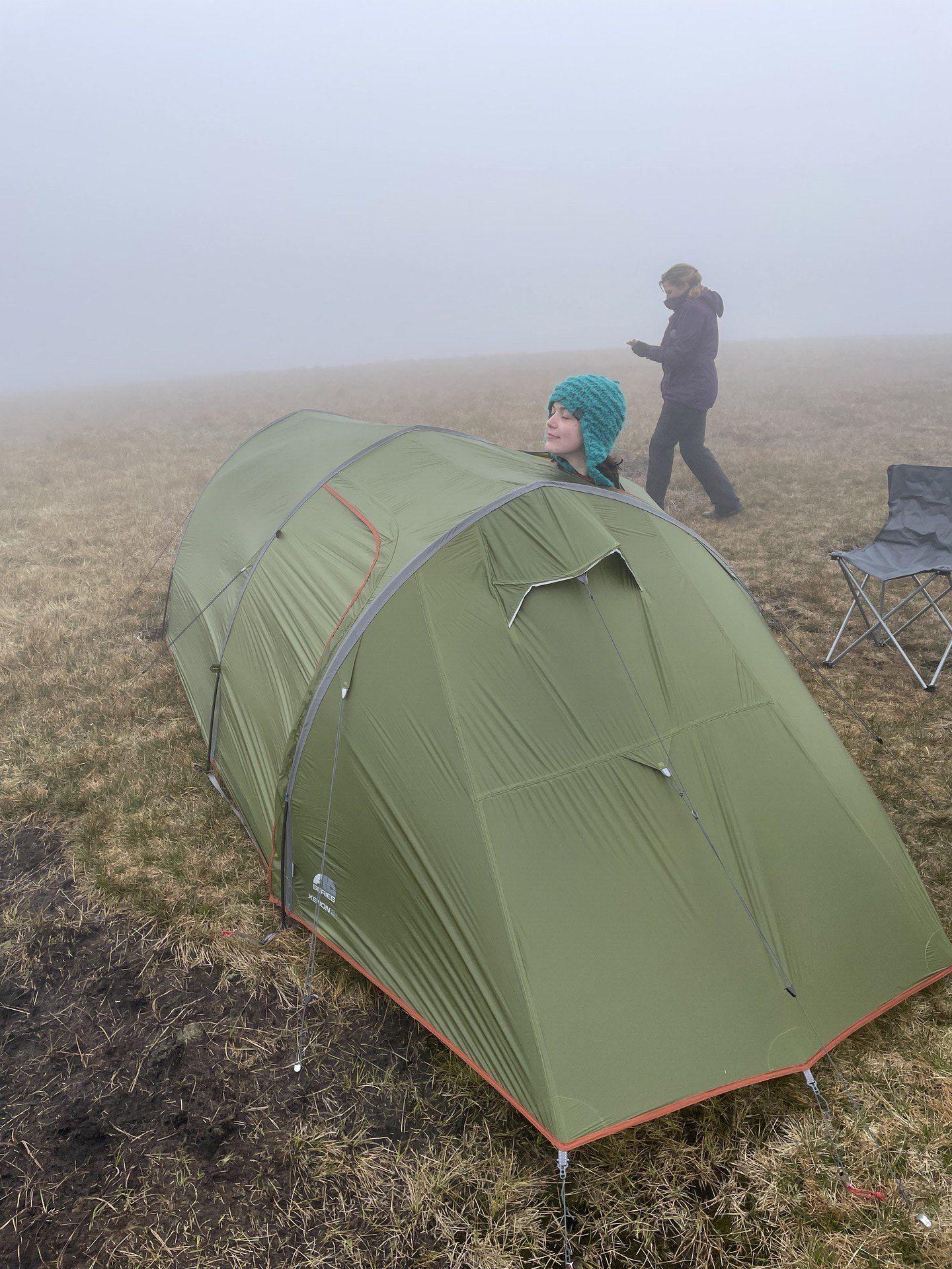 Sam poking her head out of the vestibule of our tent