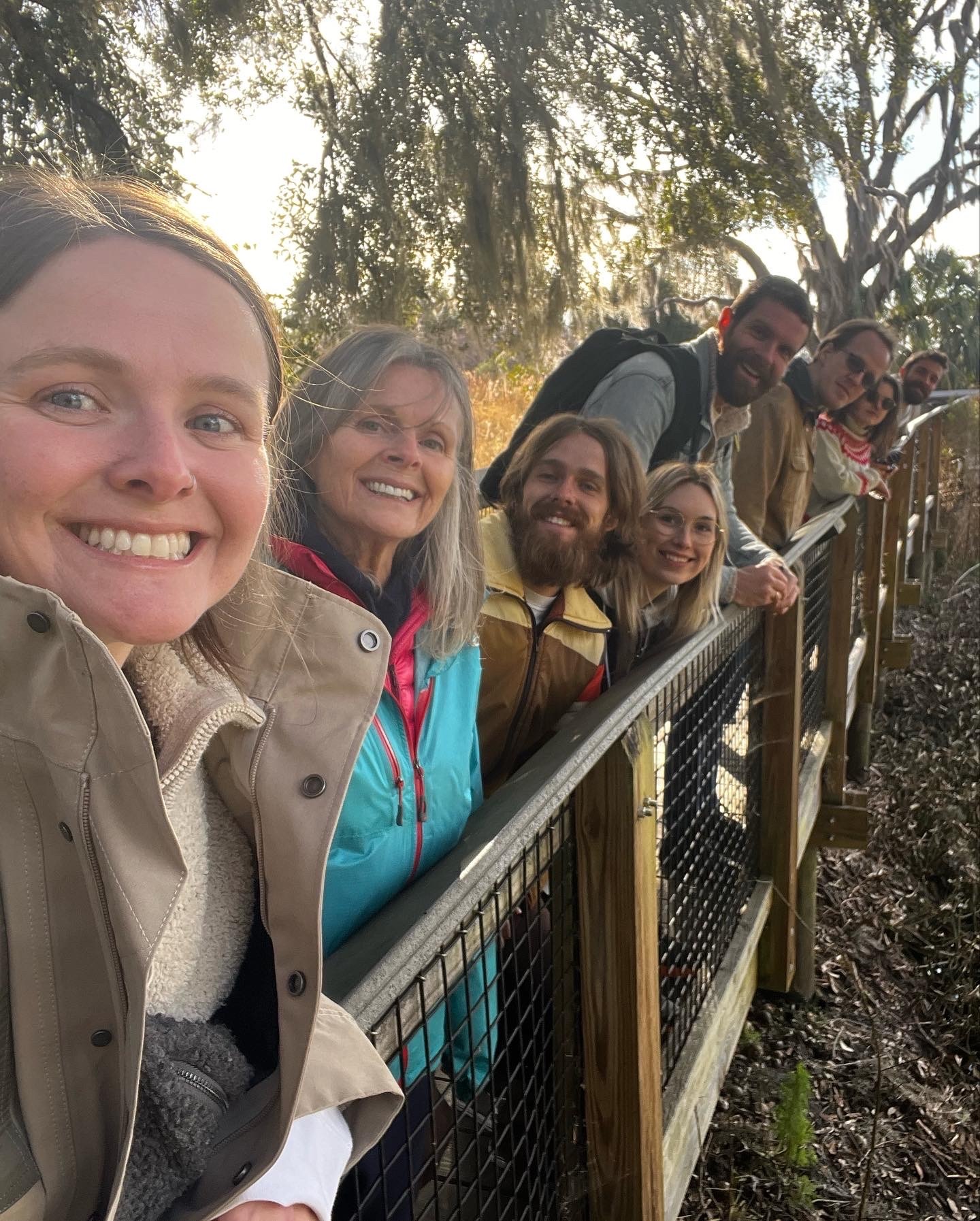 The whole family lined up at a railing on the boardwalk at Paynes Prairie