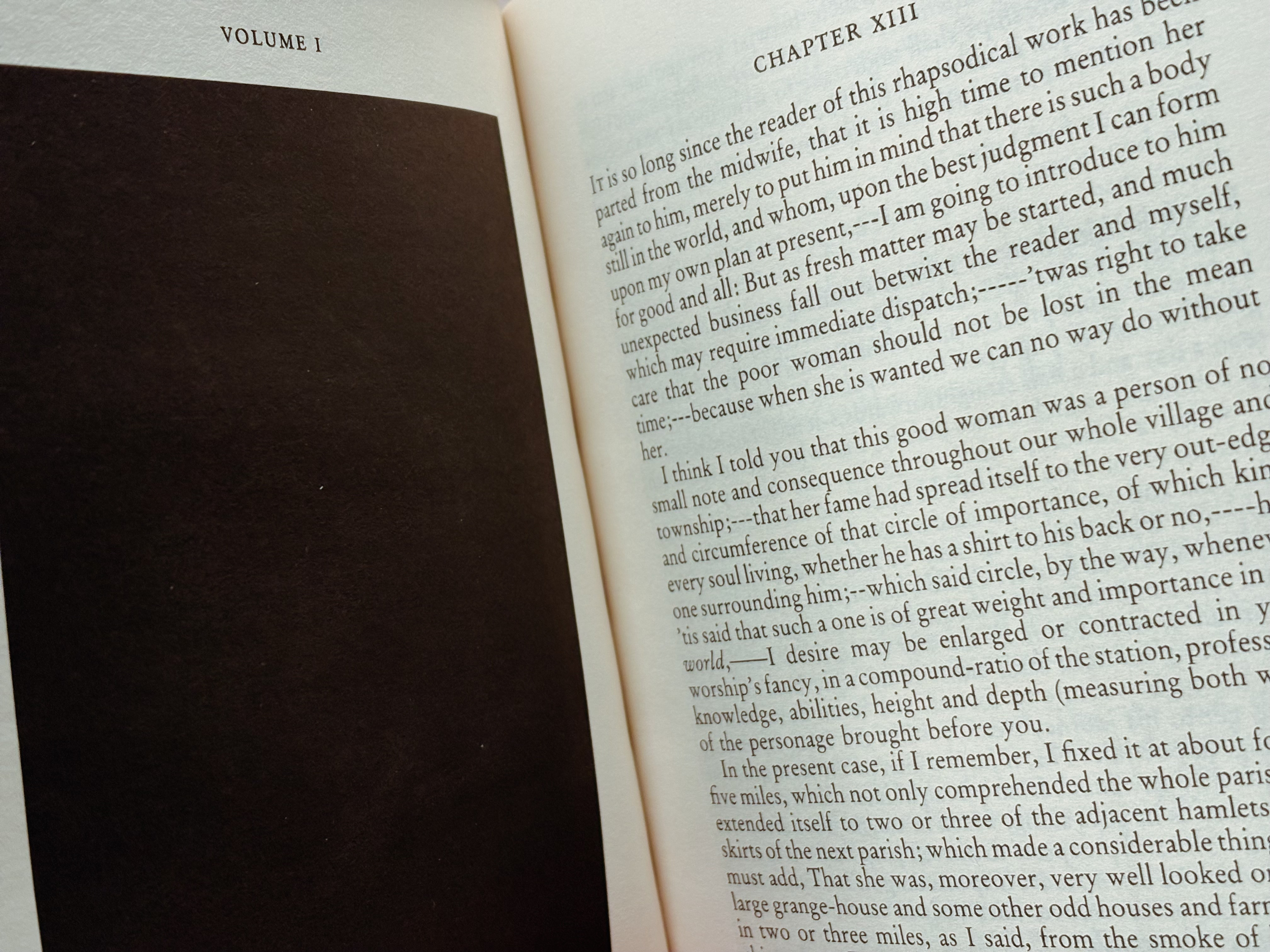 A book, open, with a big black square on the left page and chapter 8 of Tristram Shandy on the right.